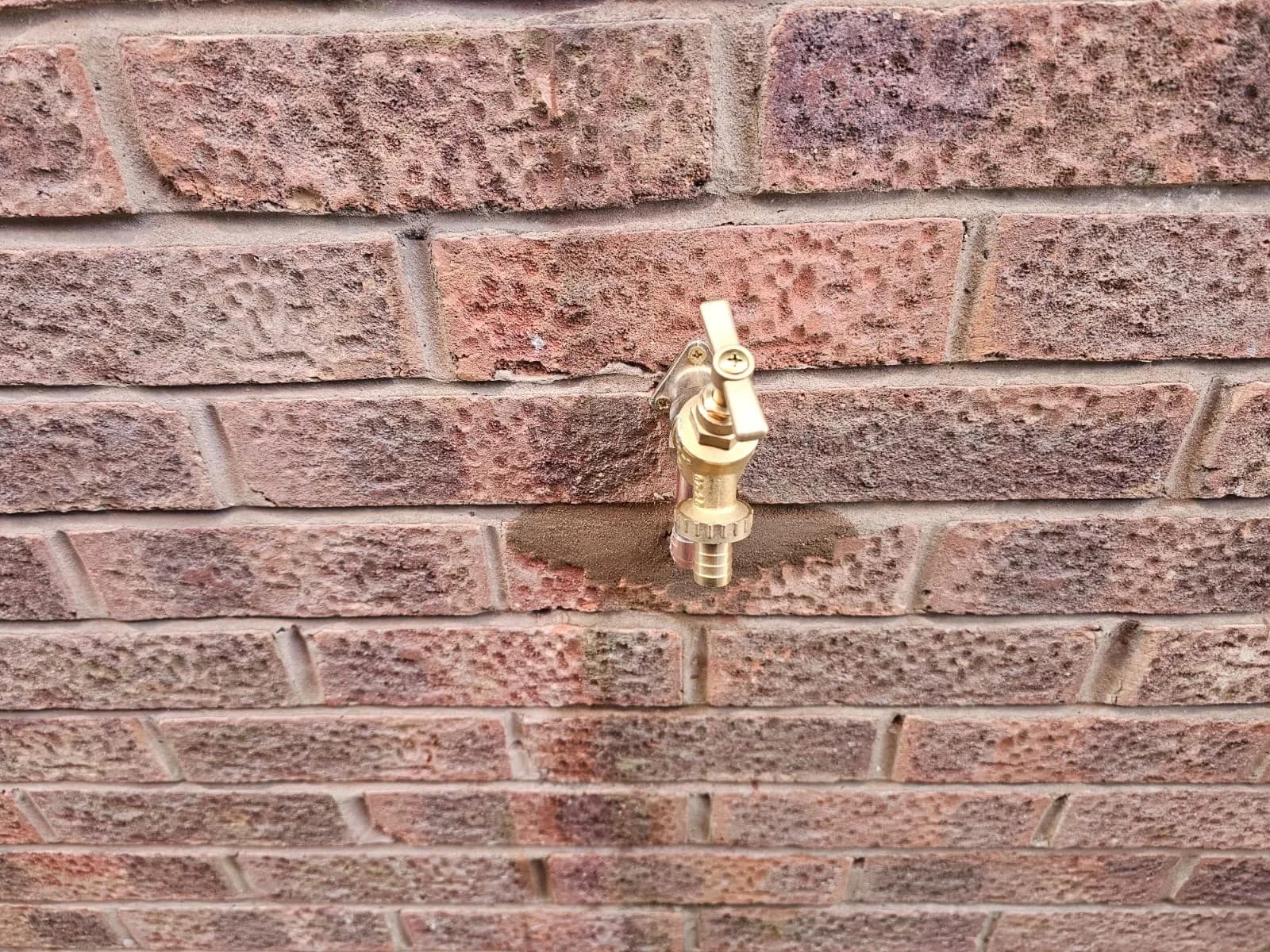 Brass tap fitting detail showing precise plumbing workmanship