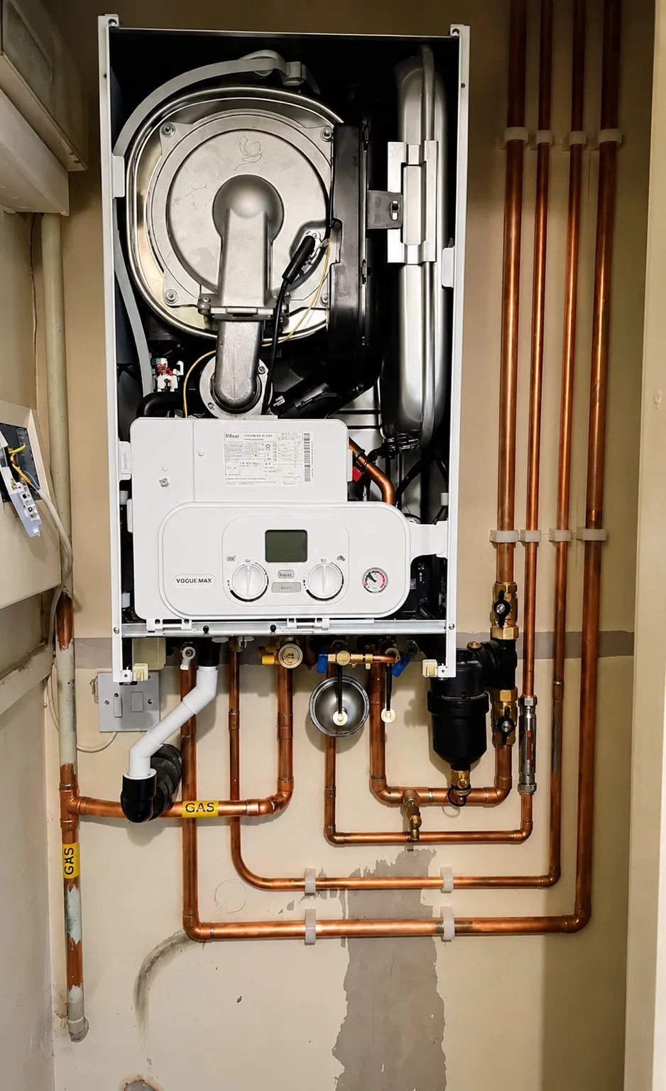 Internal components of a boiler with neat copper pipework during installation